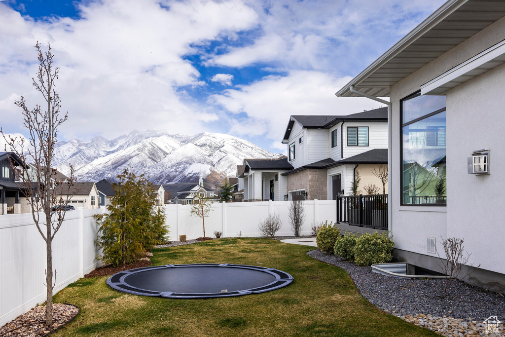 View of yard with a mountain view and a trampoline