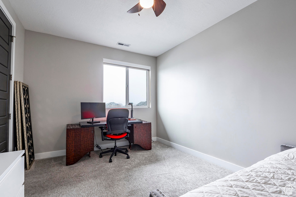 Office area with light carpet and ceiling fan