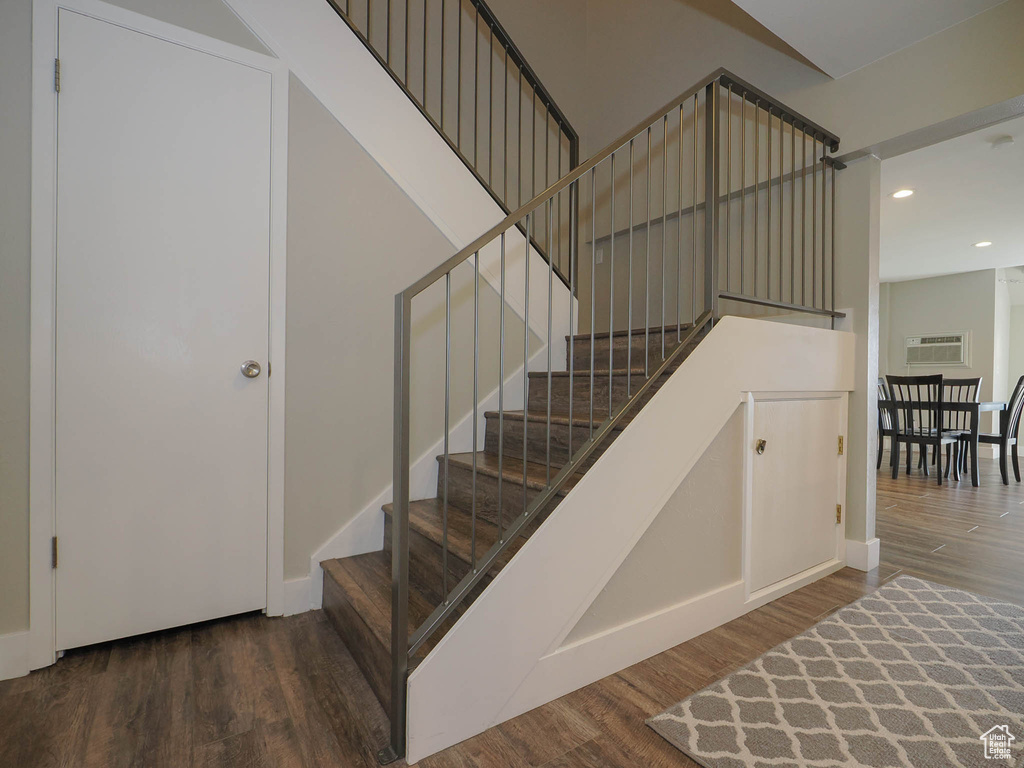 Stairway with dark hardwood / wood-style floors
