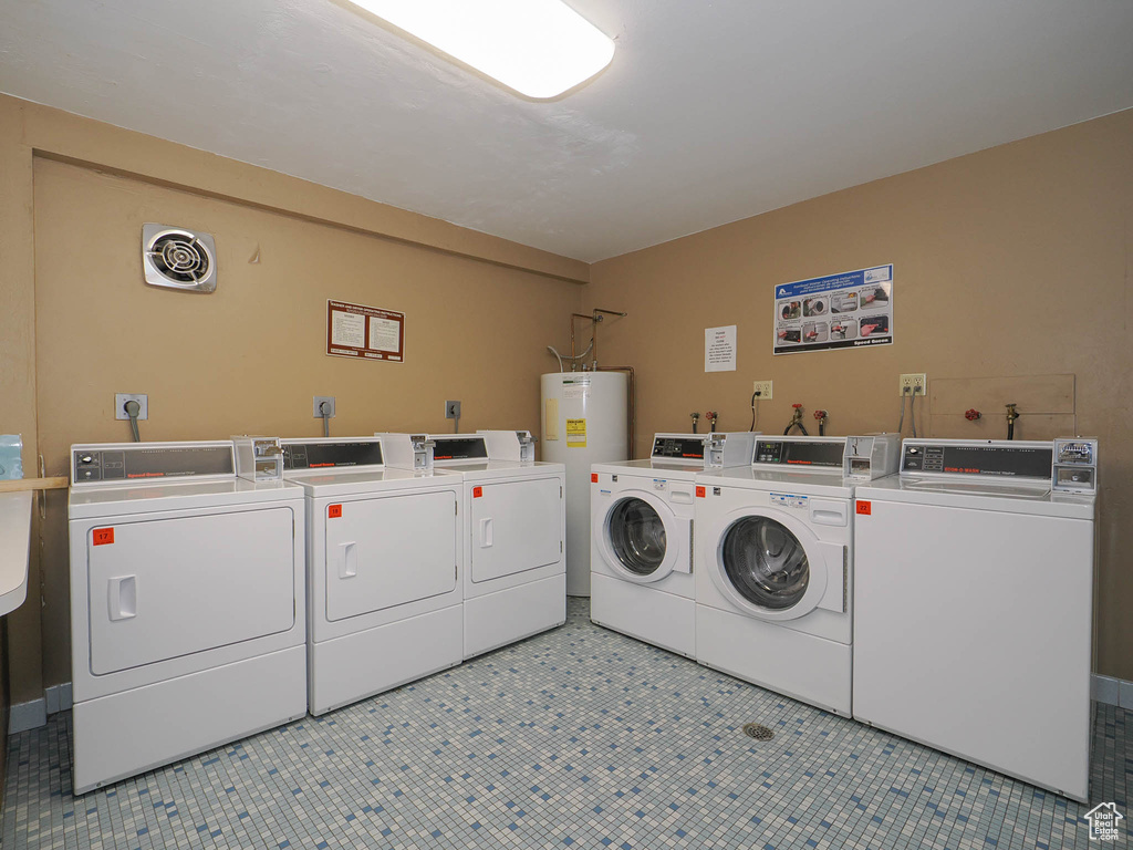 Laundry area with light tile floors, hookup for a washing machine, electric dryer hookup, water heater, and washer and dryer
