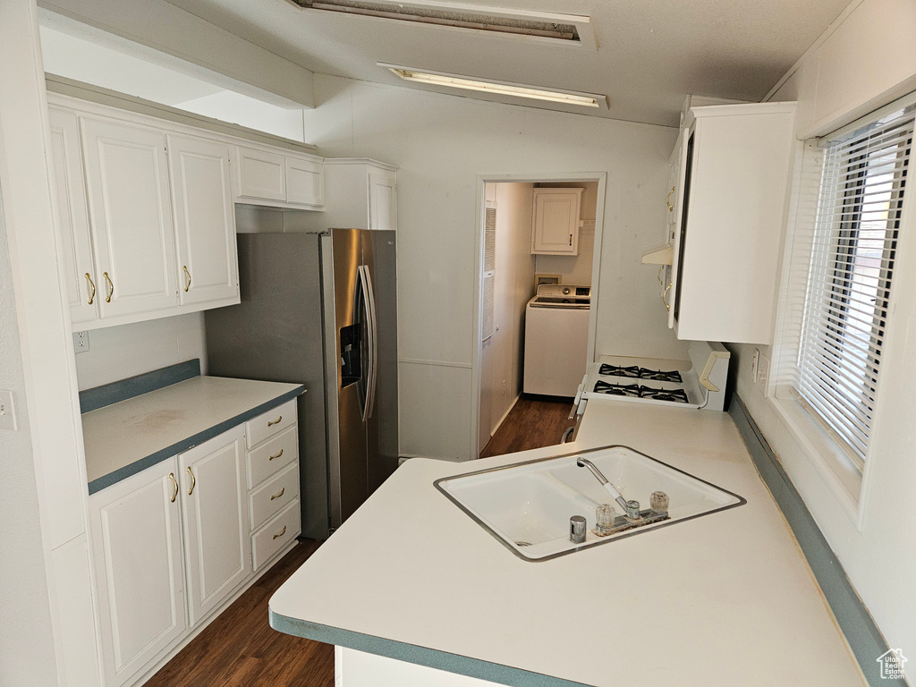 Kitchen featuring gas range gas stove, white cabinets, dark wood-type flooring, washer / clothes dryer, and stainless steel refrigerator with ice dispenser