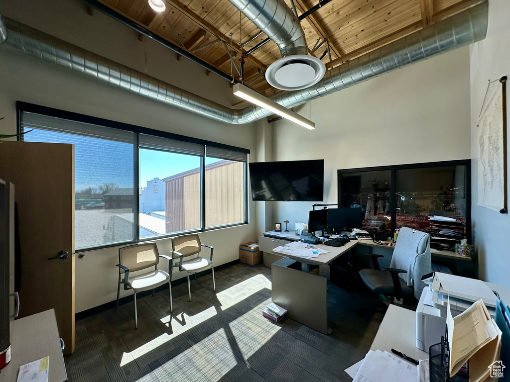 Office featuring wooden ceiling and a high ceiling