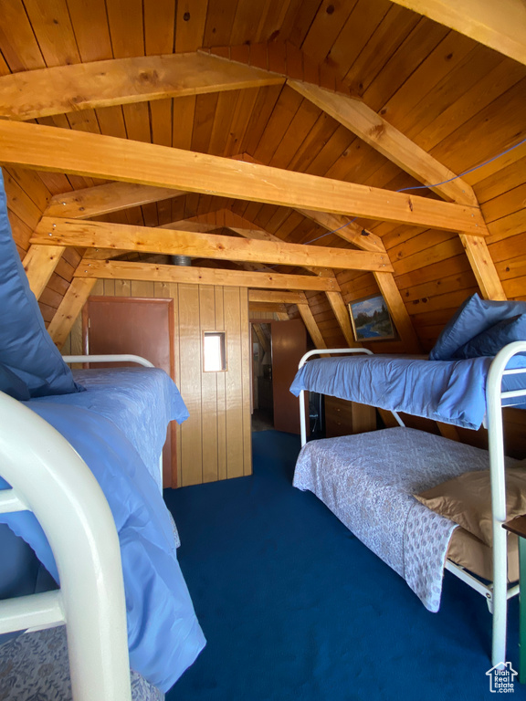 Bedroom with wooden ceiling and lofted ceiling with beams
