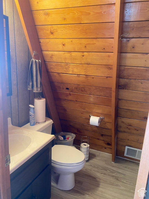 Bathroom with wood ceiling, vanity, wood walls, and hardwood / wood-style flooring