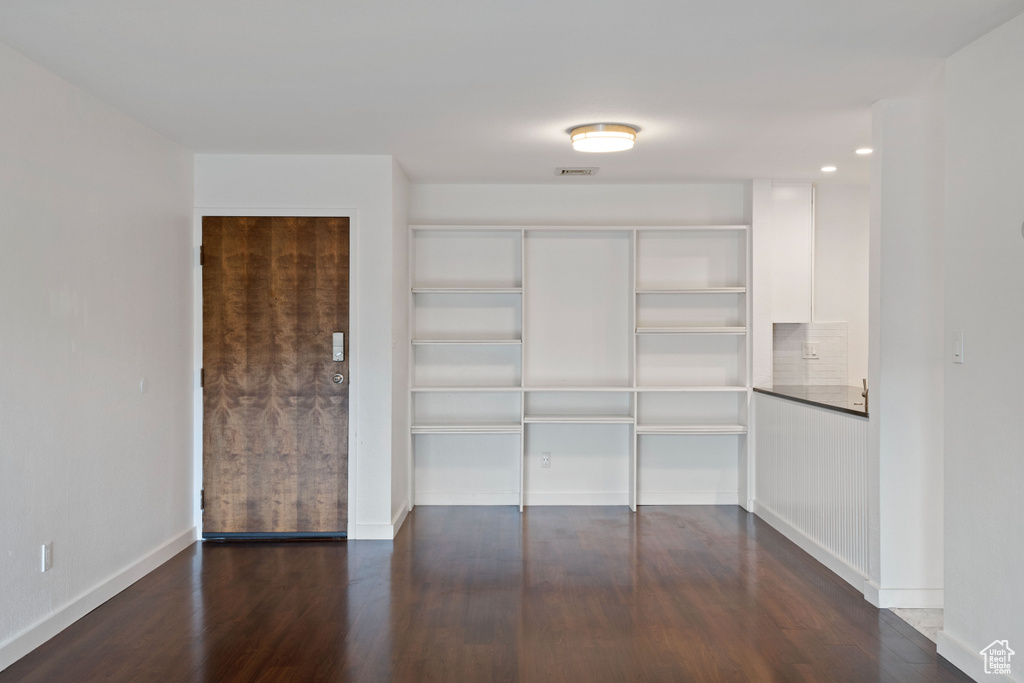 Walk in closet featuring dark hardwood / wood-style floors