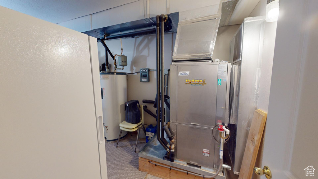 Utility room featuring water heater