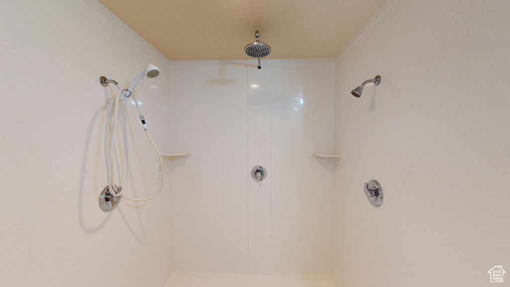 Bathroom featuring a shower and ornamental molding