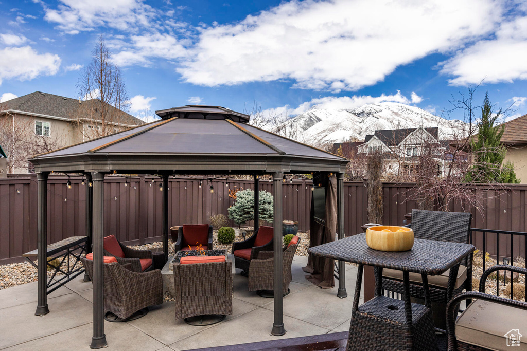 View of patio featuring a gazebo, a mountain view, and an outdoor living space