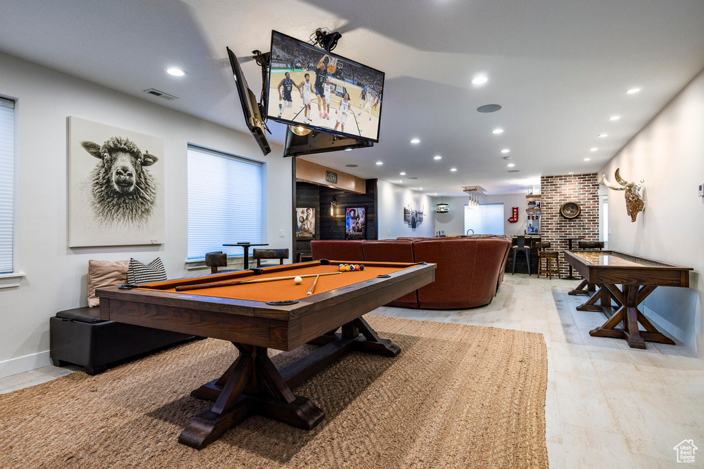 Recreation room featuring brick wall, pool table, and light tile floors