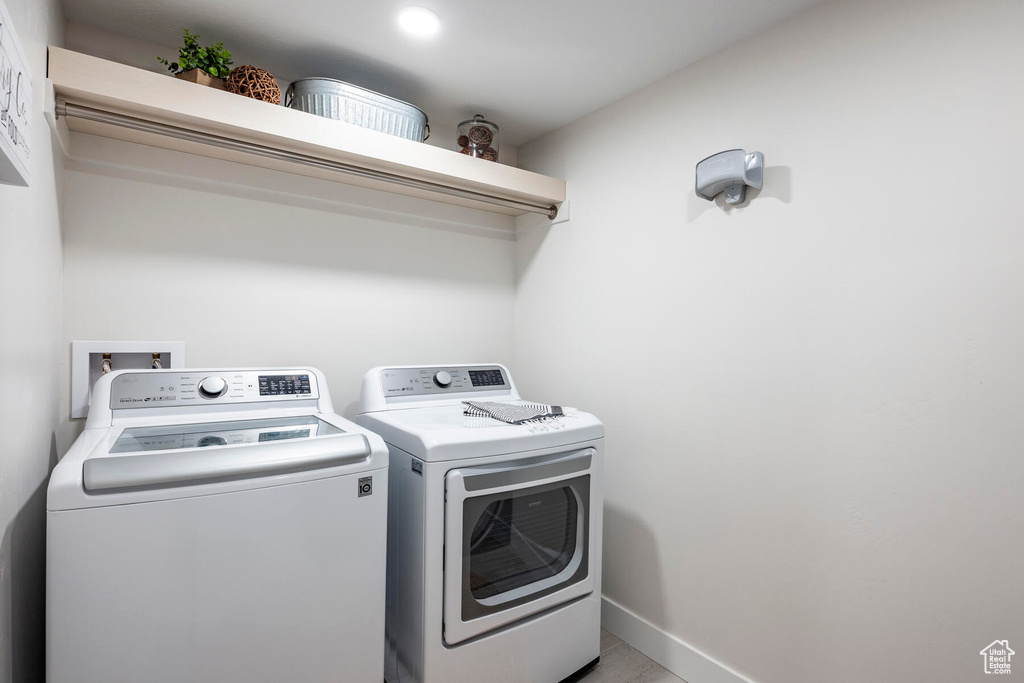 Clothes washing area featuring washer and clothes dryer and hookup for a washing machine