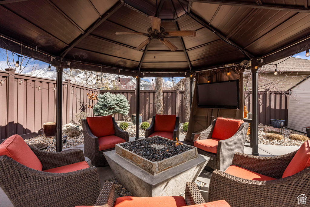 View of patio featuring a gazebo, an outdoor hangout area, and ceiling fan