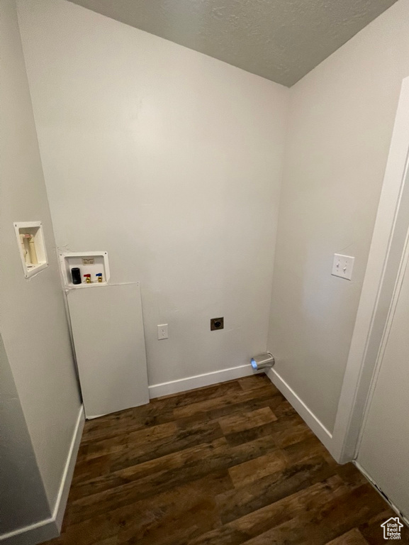 Laundry area with hookup for a washing machine, dark hardwood / wood-style flooring, and a textured ceiling