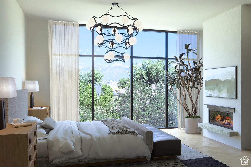 Bedroom featuring expansive windows and light hardwood / wood-style floors