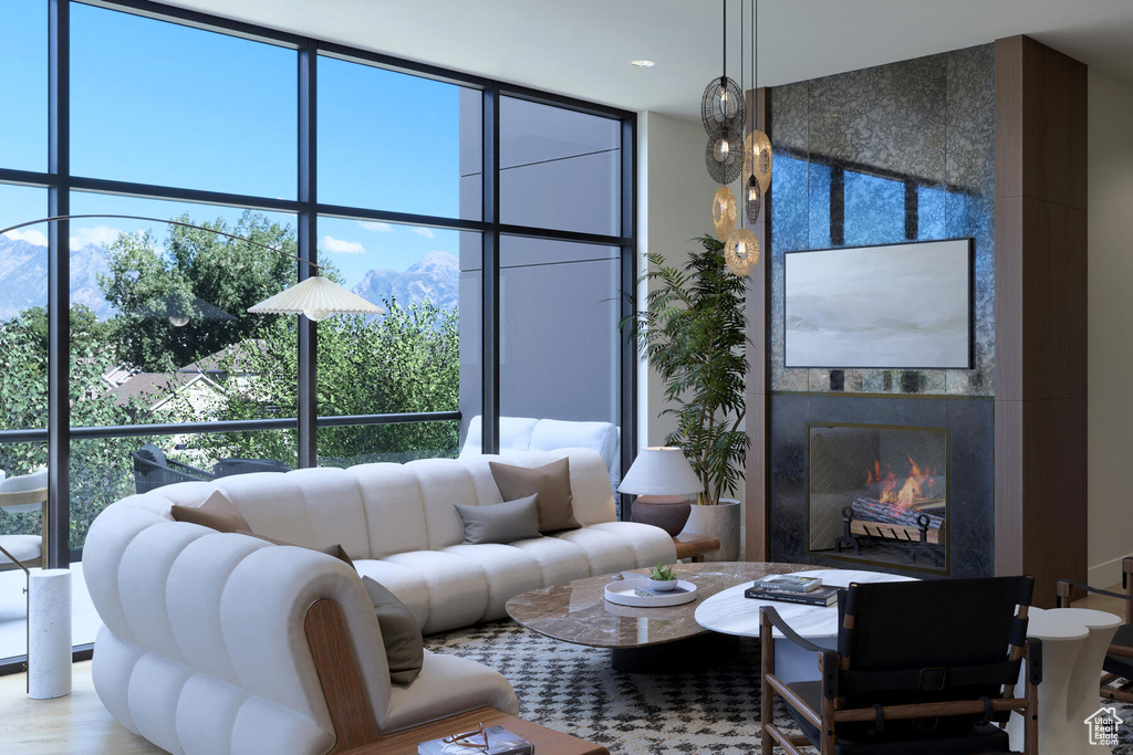 Living room featuring a tiled fireplace and a wealth of natural light