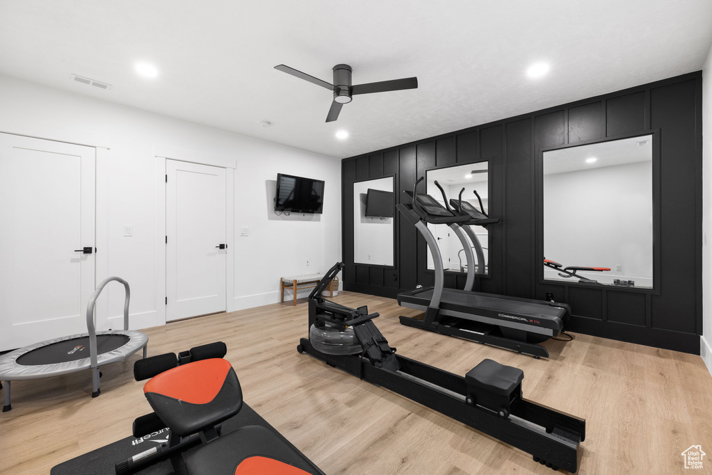 Exercise room featuring light hardwood / wood-style floors and ceiling fan