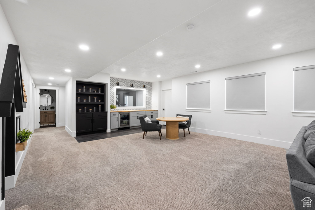 Carpeted living room with beverage cooler