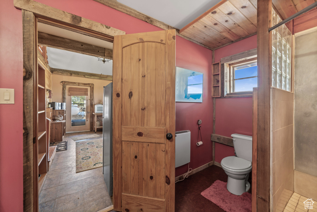 Bathroom featuring tile floors, a wealth of natural light, and toilet