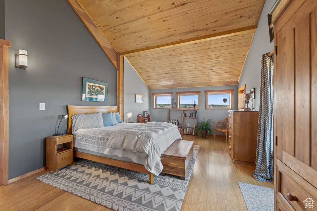 Bedroom featuring wood ceiling, light hardwood / wood-style floors, and lofted ceiling
