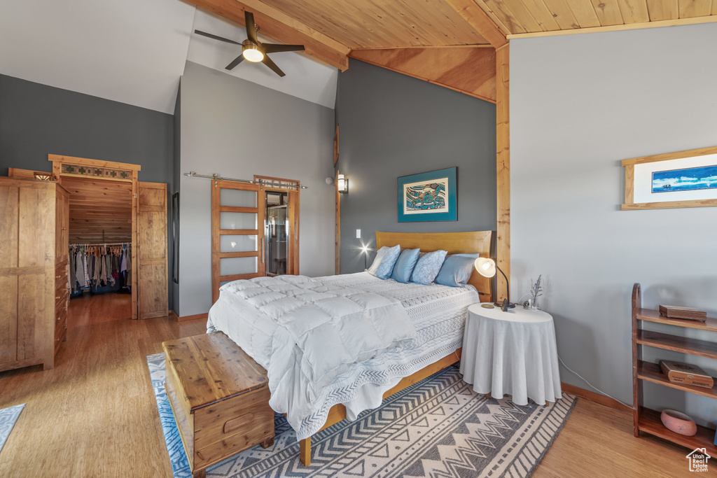 Bedroom featuring wooden ceiling, beamed ceiling, light wood-type flooring, and ceiling fan