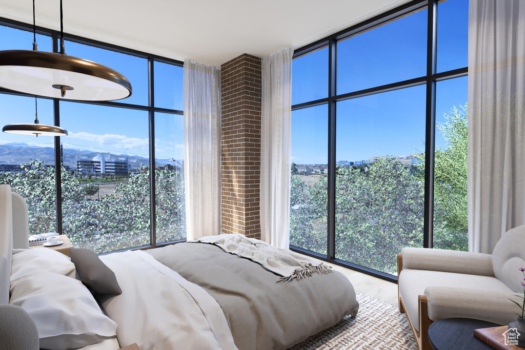 Bedroom featuring expansive windows and multiple windows