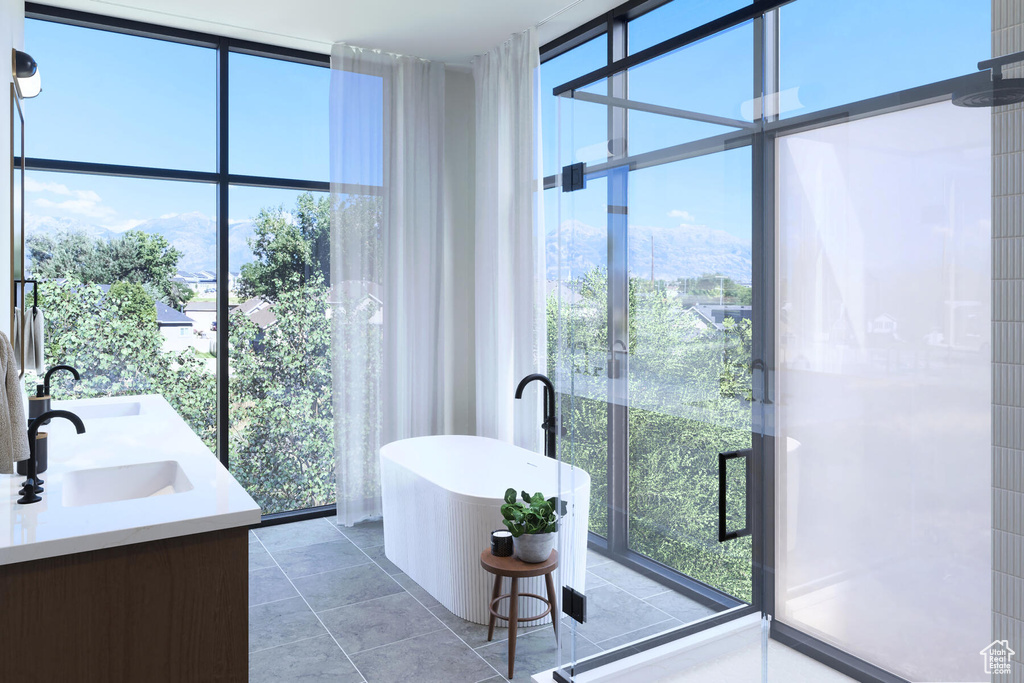 Bathroom featuring tile floors, dual bowl vanity, and a wealth of natural light