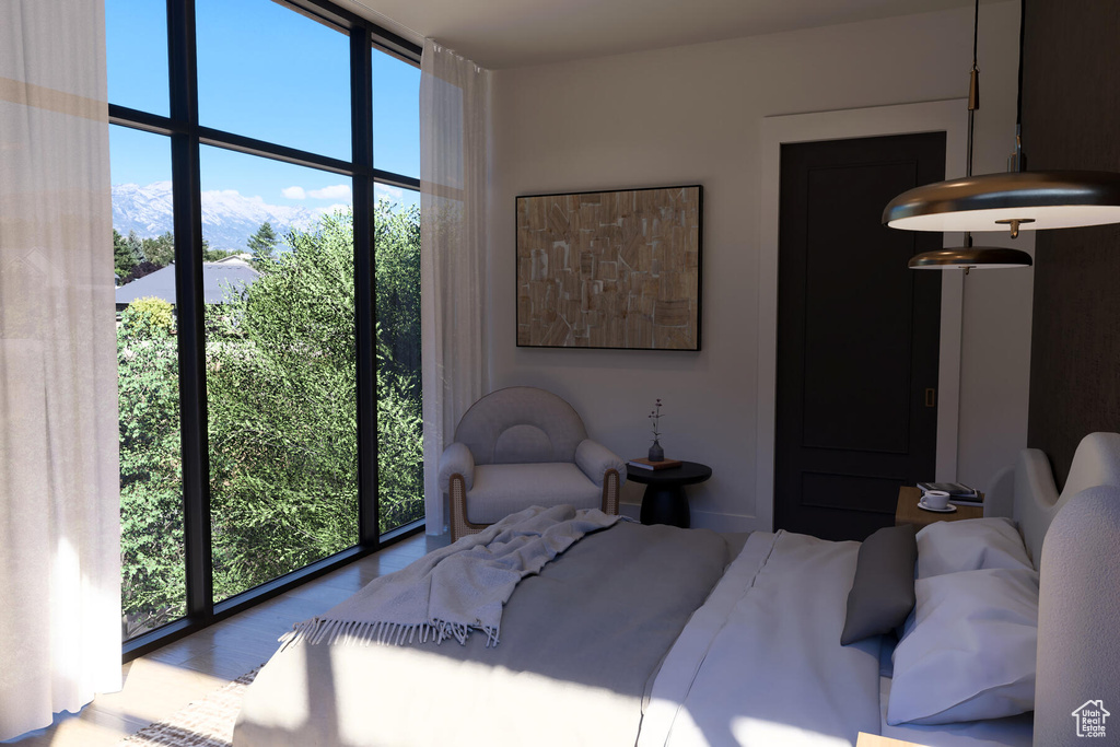 Bedroom with floor to ceiling windows and multiple windows