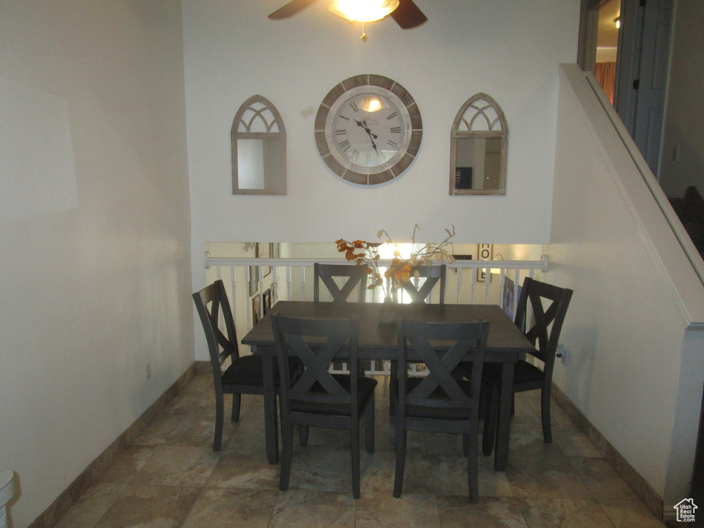 Dining room with dark tile floors and ceiling fan