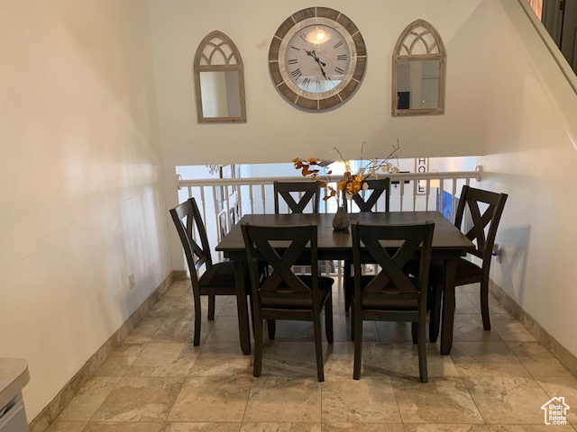 Tiled dining space with a high ceiling