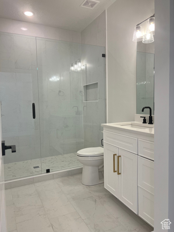 Bathroom featuring vanity, tile flooring, a shower with door, and toilet