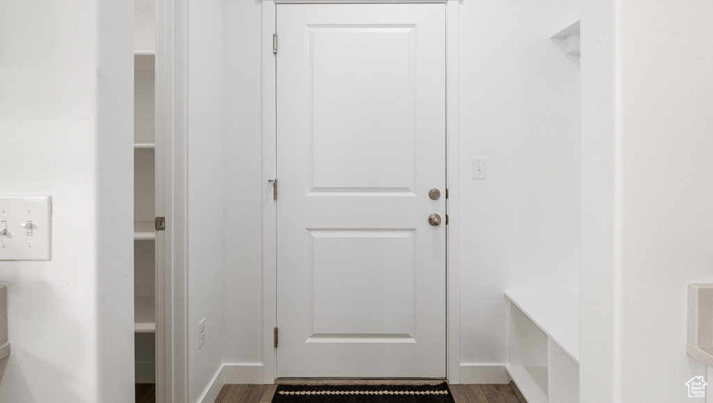 Doorway to outside with dark wood-type flooring