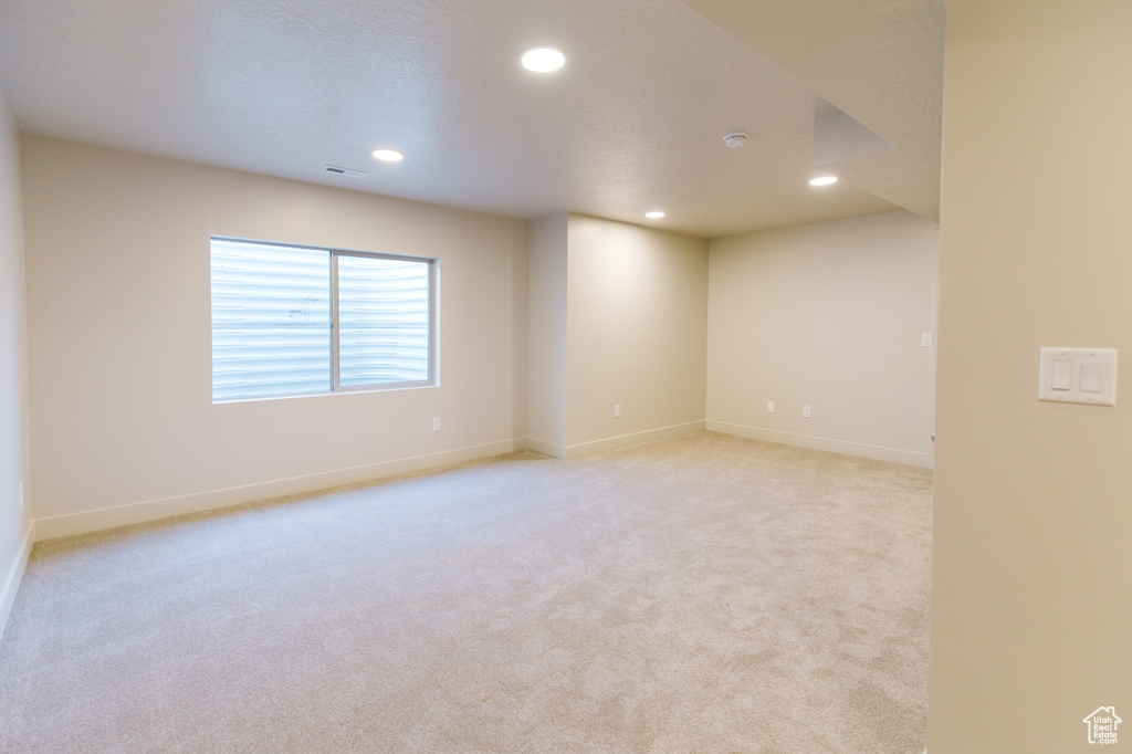 Spare room featuring light colored carpet