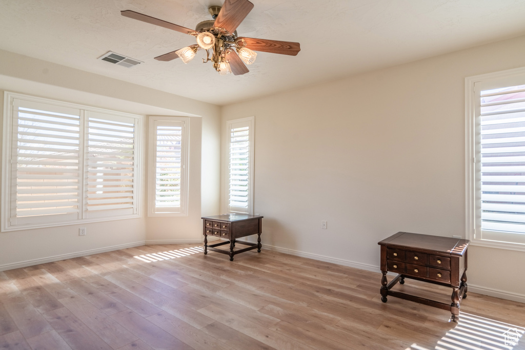 Sitting room featuring ceiling fan and light hardwood / wood-style flooring