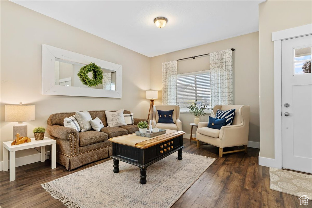 Living room featuring plenty of natural light and dark hardwood / wood-style floors