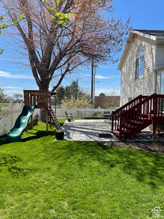 View of yard with a patio area and a playground