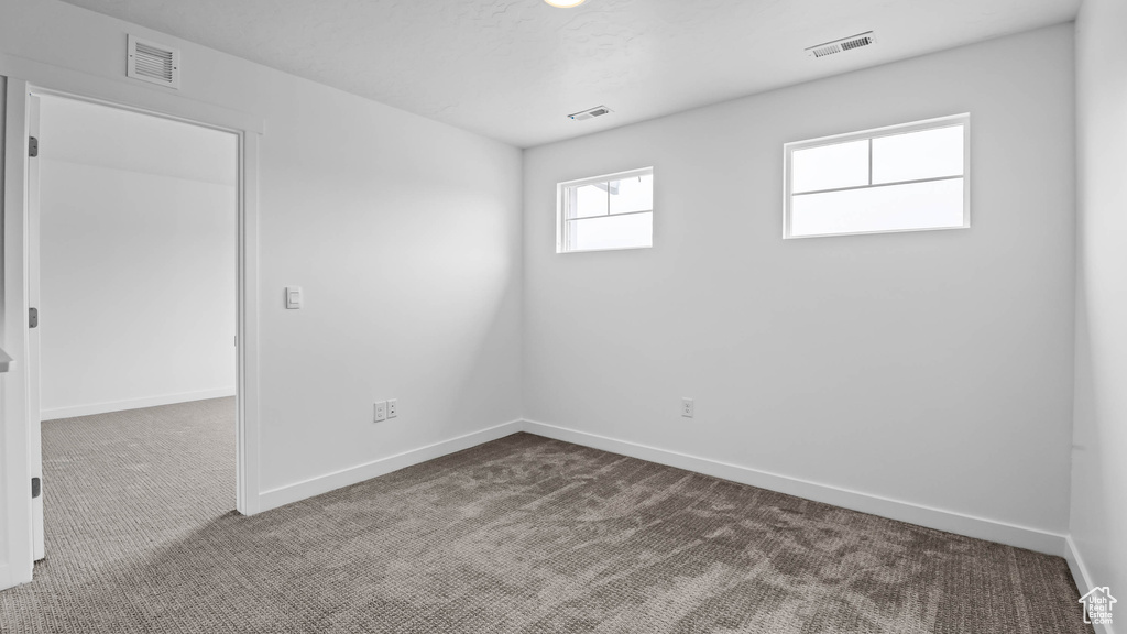 Spare room with dark carpet