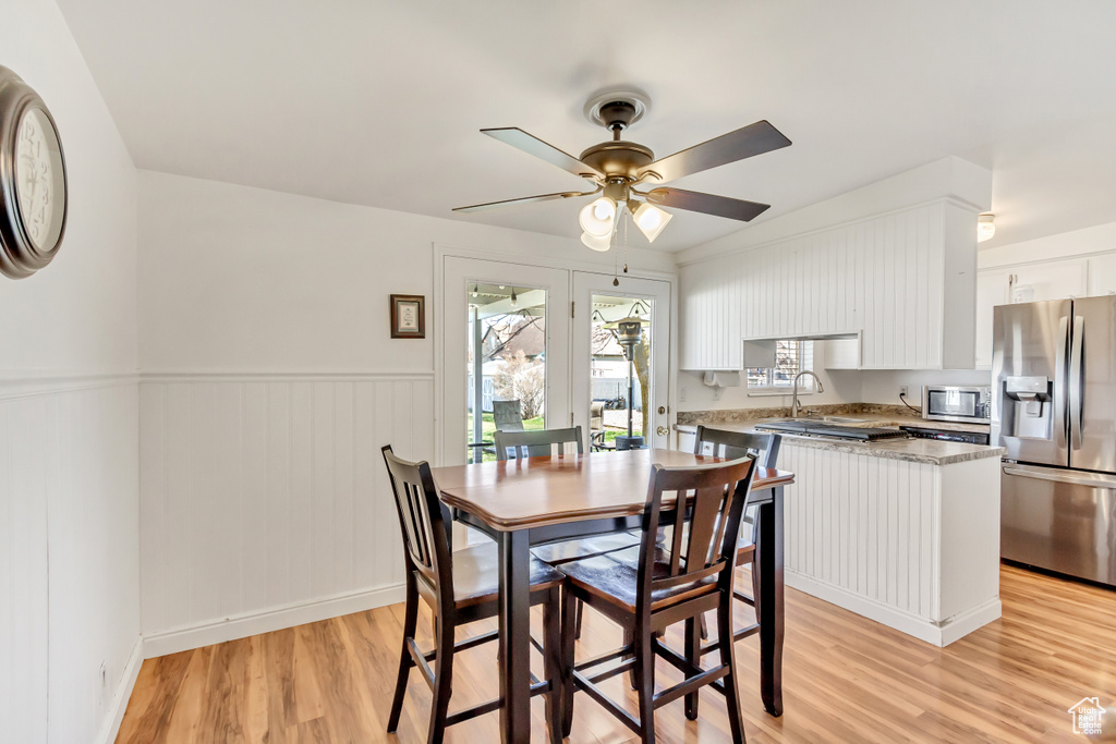 Dining space with light hardwood / wood-style floors, sink, and ceiling fan