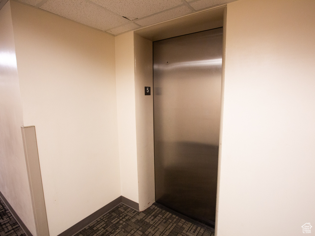 Interior space with a drop ceiling and elevator