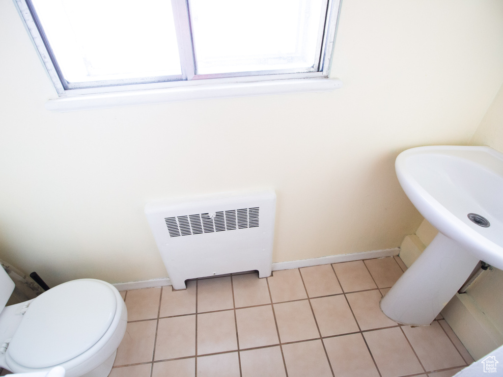 Bathroom featuring toilet, tile flooring, and radiator