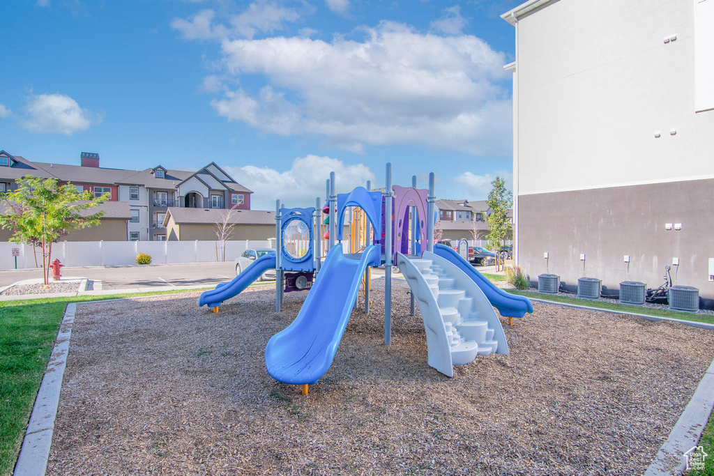 View of jungle gym with central air condition unit