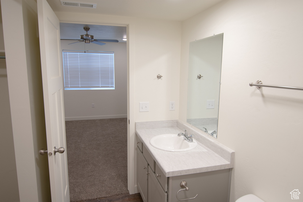 Bathroom featuring ceiling fan and vanity