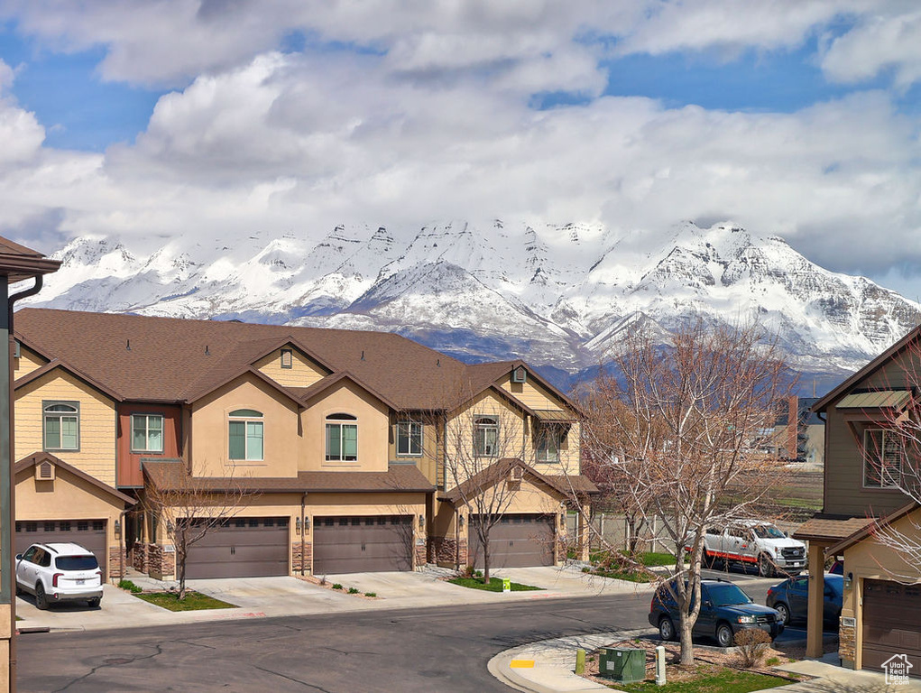 View of front of home featuring a mountain view and a garage