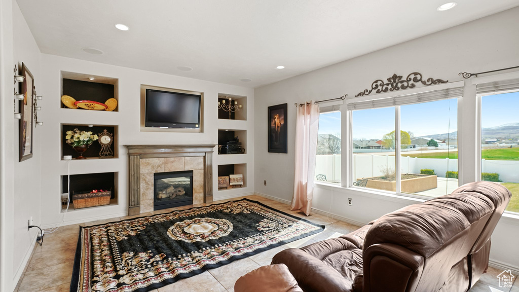 Living room featuring light tile flooring and a tile fireplace
