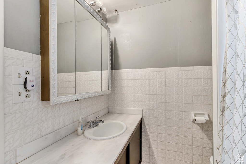 Bathroom with tile walls and oversized vanity