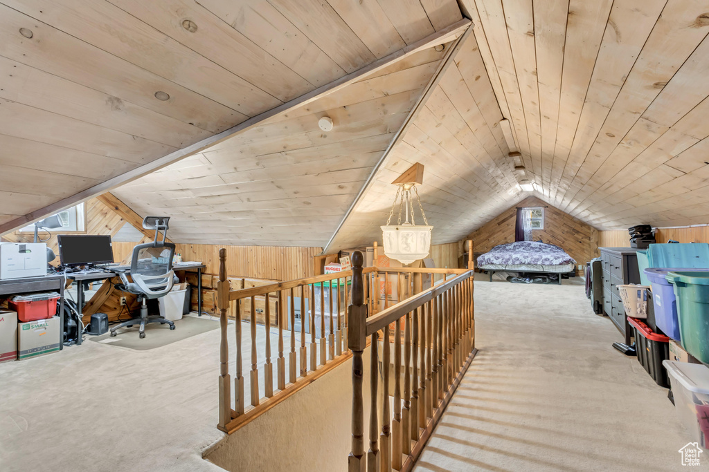 Bedroom with wood walls, wooden ceiling, and vaulted ceiling
