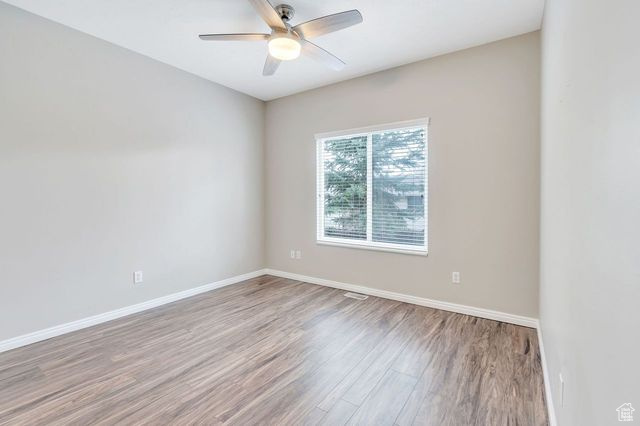 Spare room featuring light hardwood / wood-style floors and ceiling fan