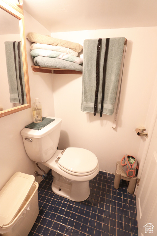 Bathroom featuring toilet and tile floors