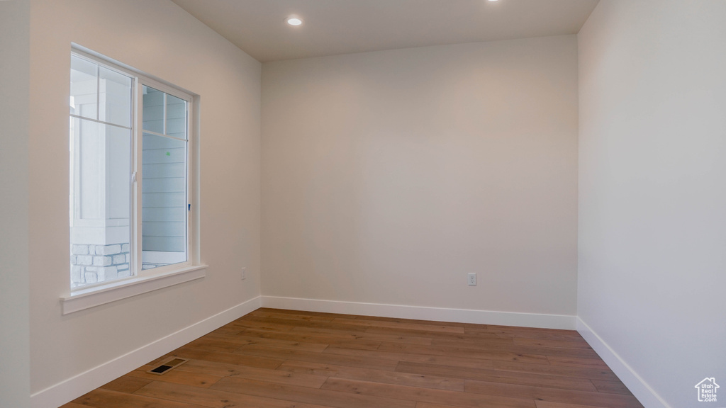 Spare room with dark hardwood / wood-style flooring