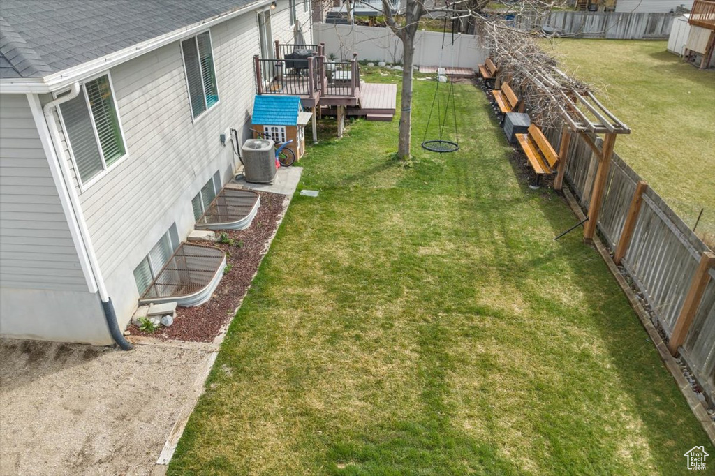 View of yard featuring a deck and central air condition unit