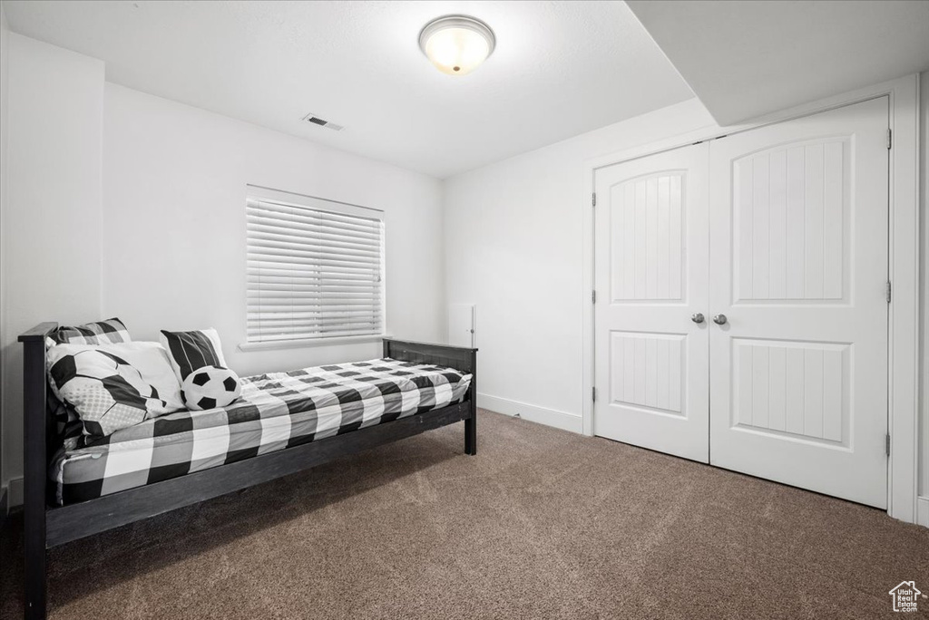 Bedroom featuring a closet and carpet
