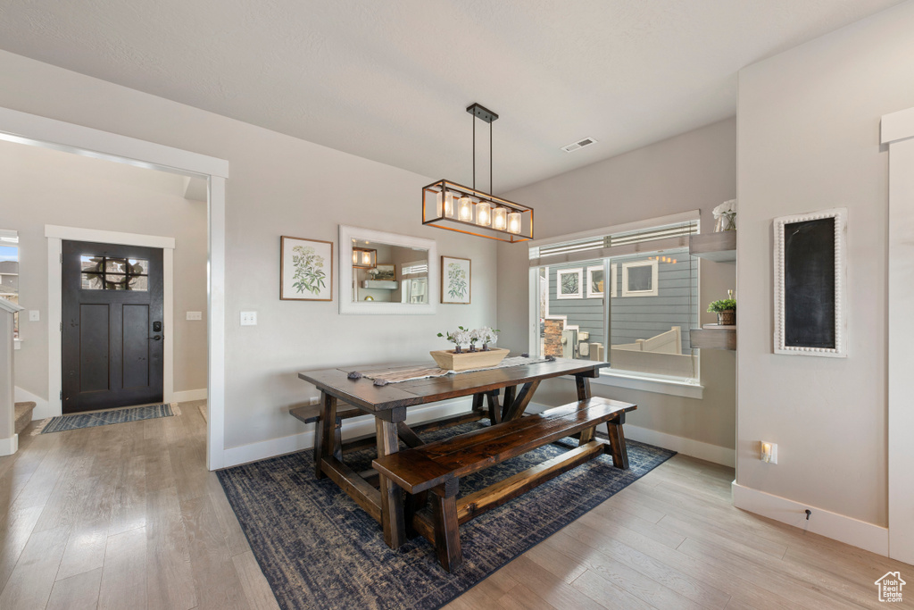 Dining room featuring a notable chandelier and light hardwood / wood-style floors